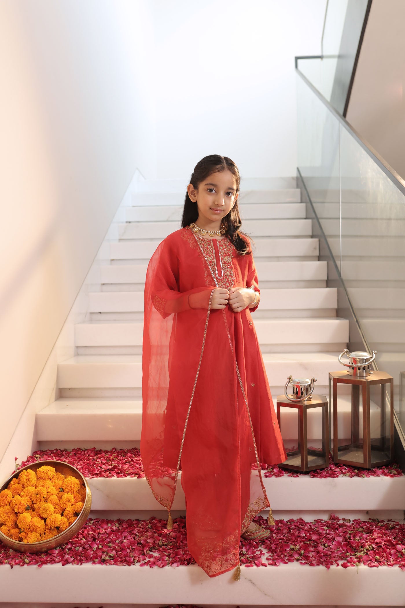 Vibrant red suit adorned with delicate golden zari embroidery and subt