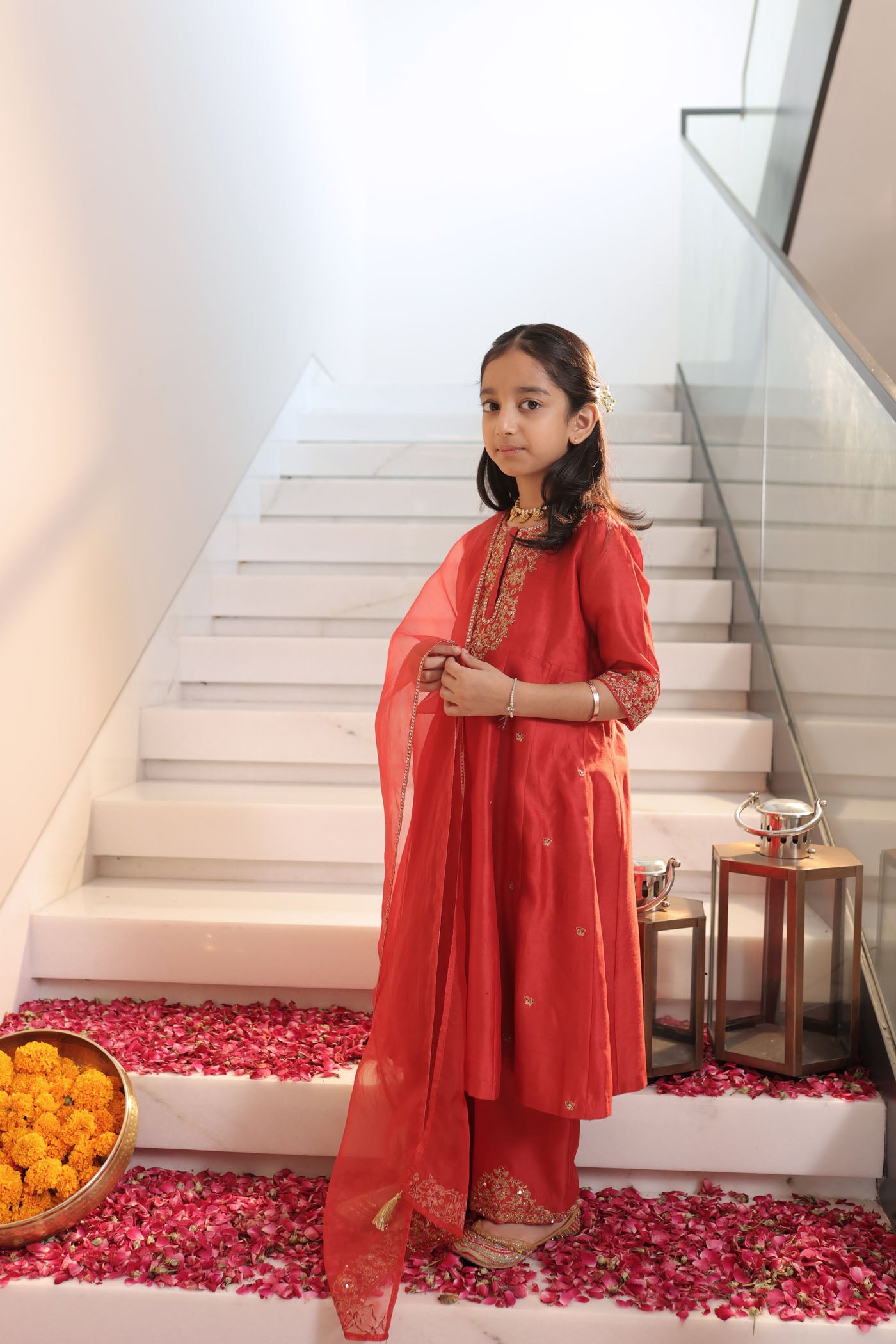 Vibrant red suit adorned with delicate golden zari embroidery and subtle detailing for an elegant festive charm