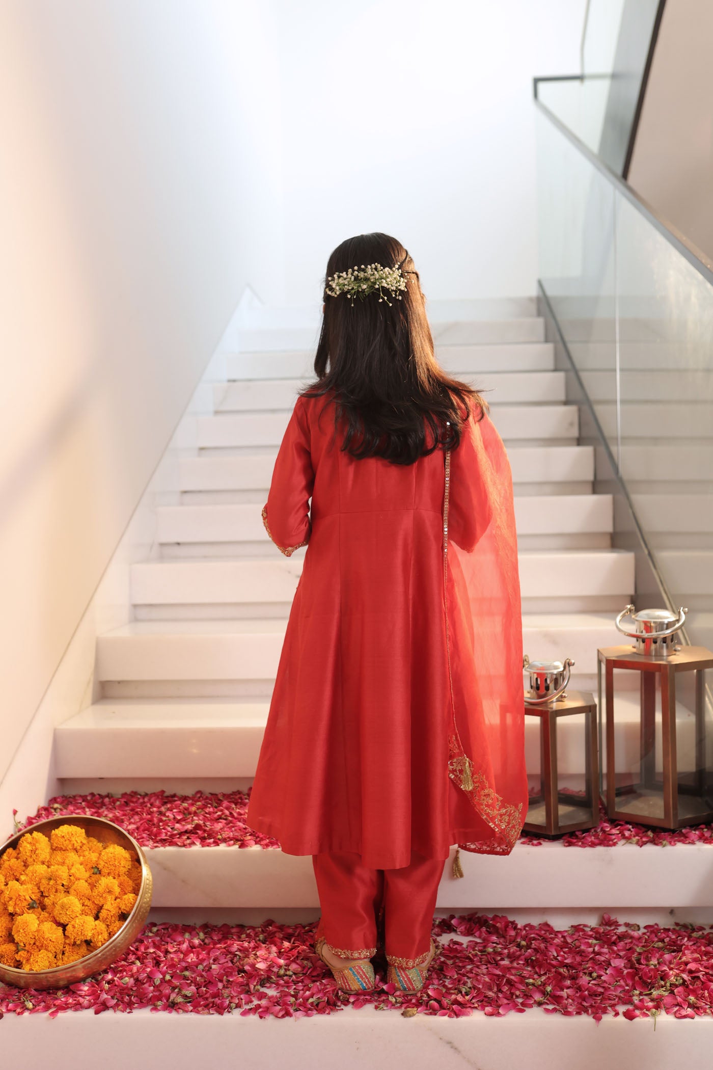 Vibrant red suit adorned with delicate golden zari embroidery and subtle detailing for an elegant festive charm