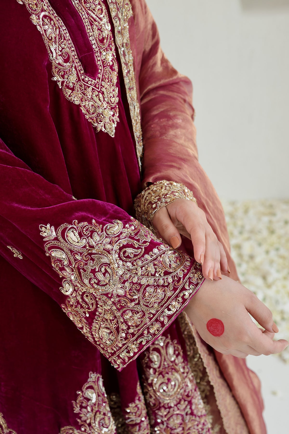Bright pink velvet paired with a soft blush dupatta and intricate antique-gold embroidery