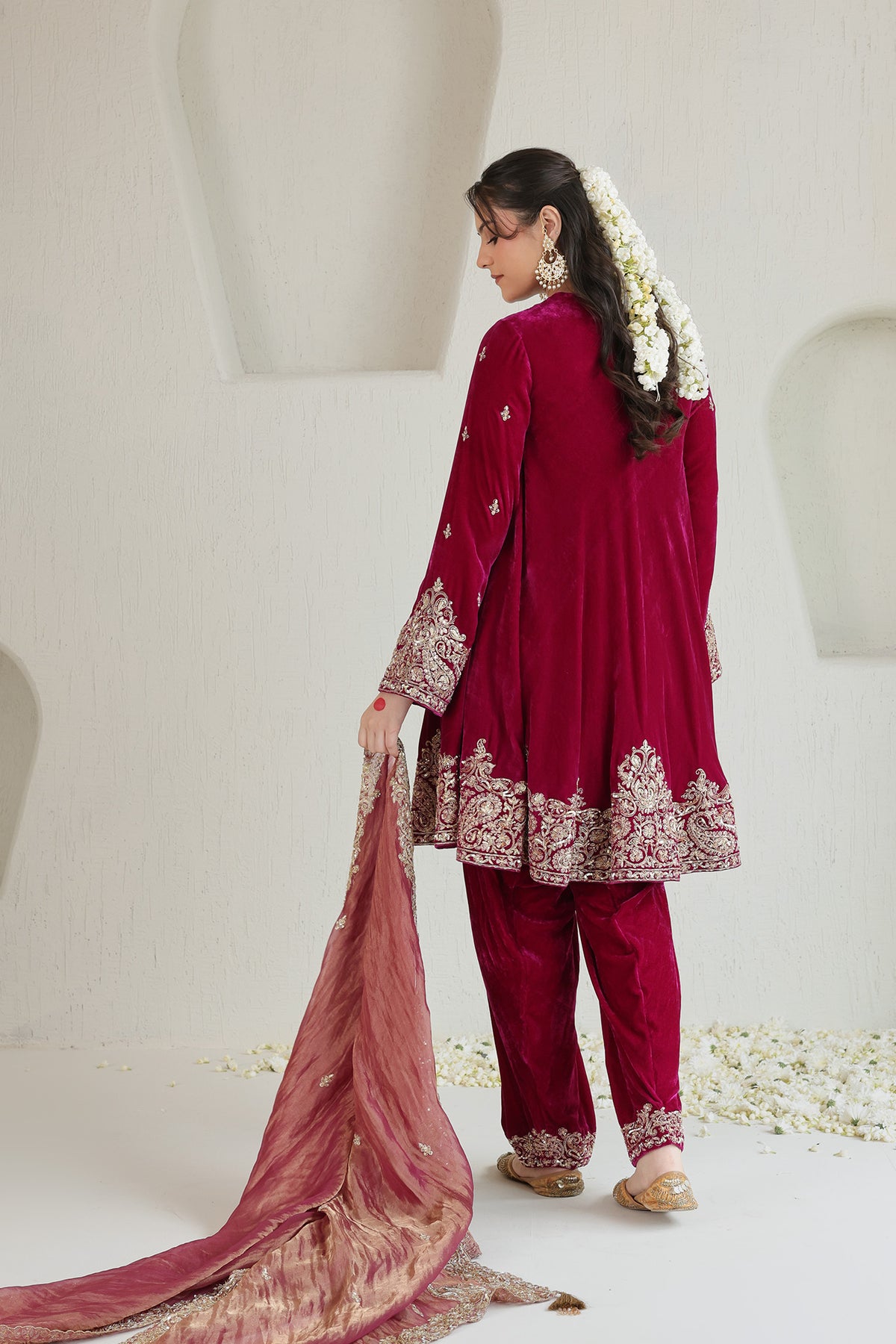 Bright pink velvet paired with a soft blush dupatta and intricate antique-gold embroidery