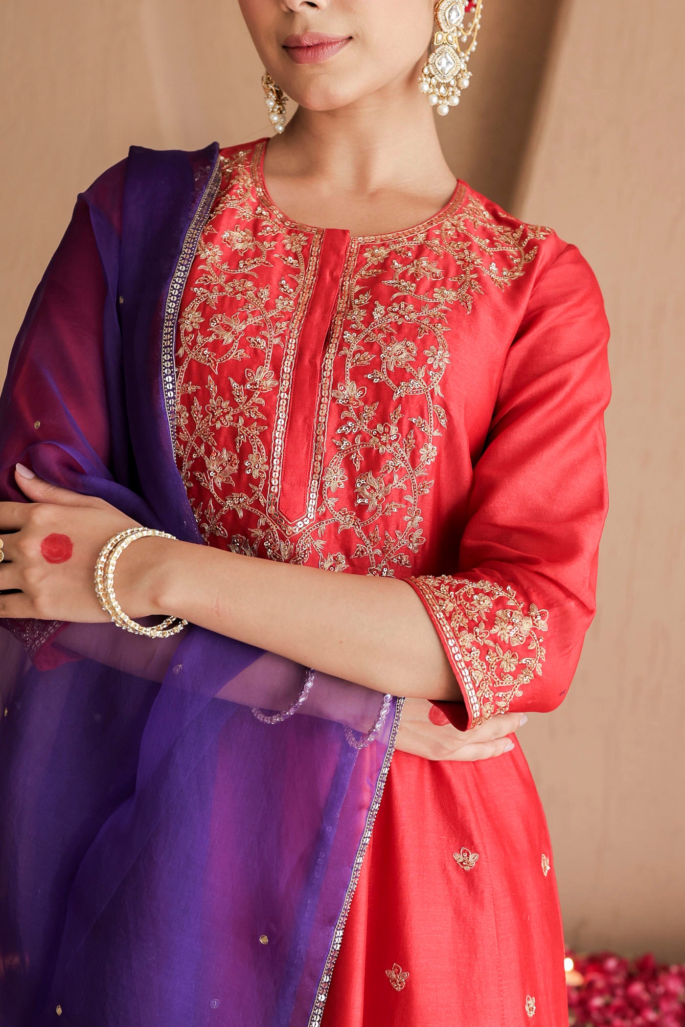 Red kurta set with purple dupatta and fine embellishments