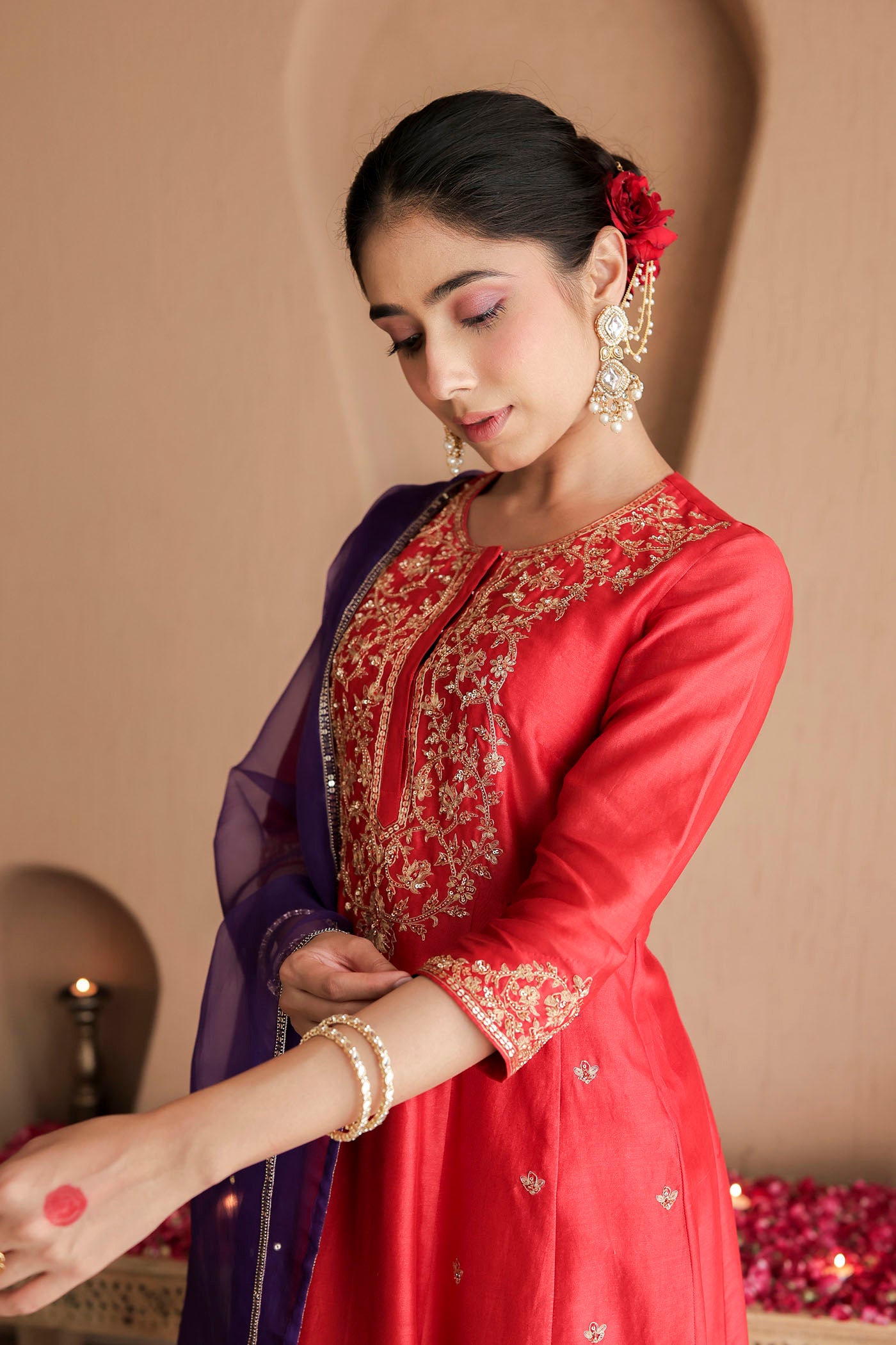 Red kurta set with purple dupatta and fine embellishments