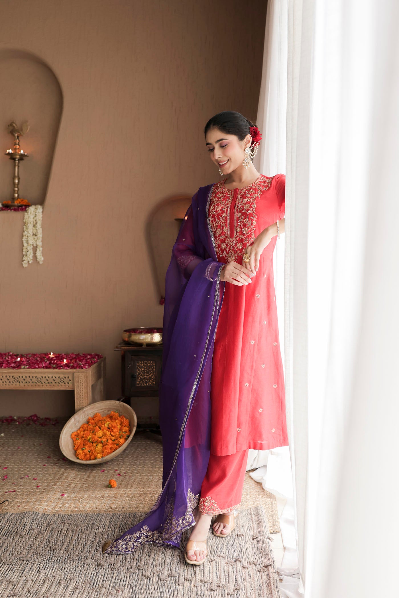 Red kurta set with purple dupatta and fine embellishments
