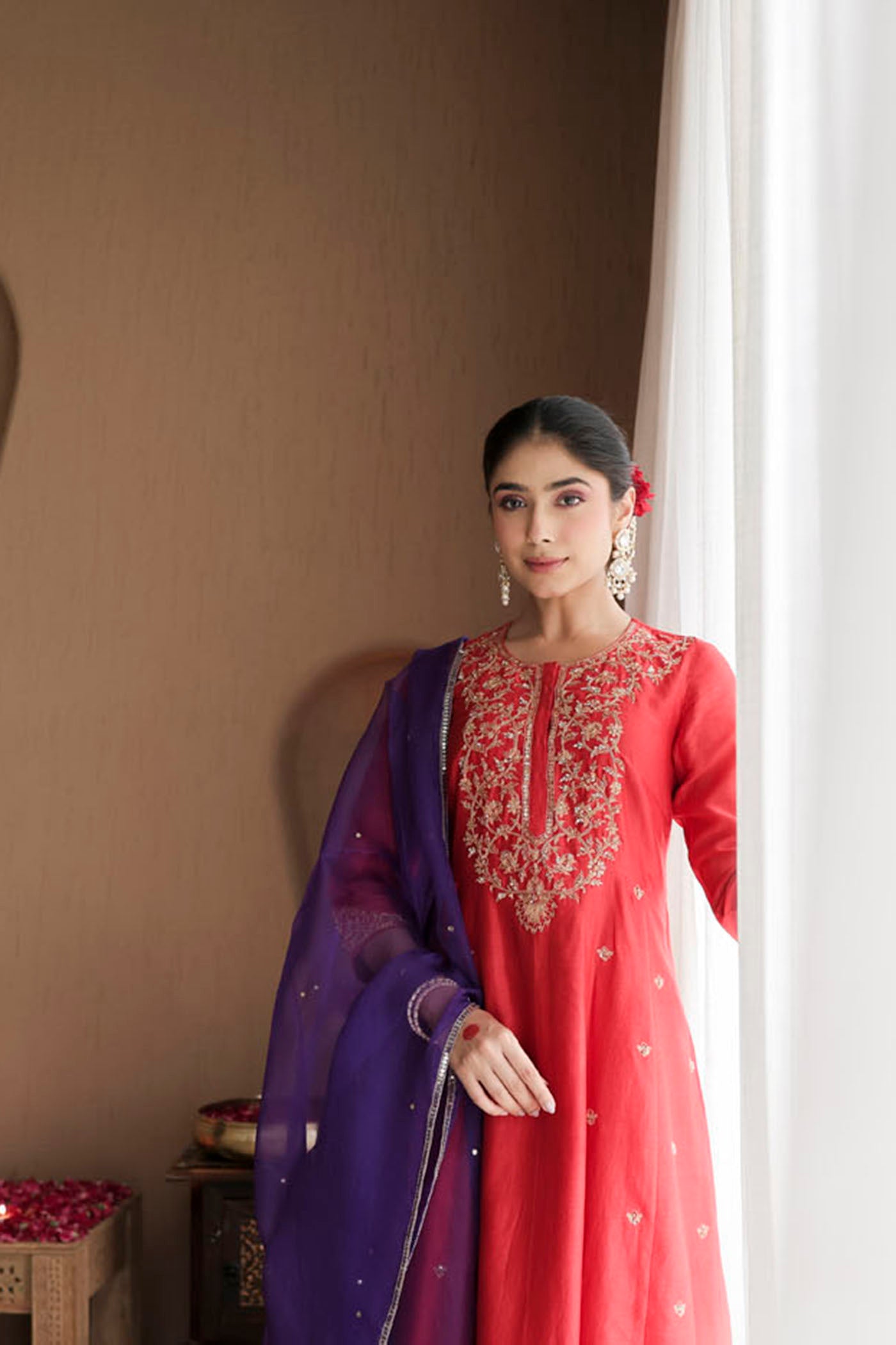 Red kurta set with purple dupatta and fine embellishments