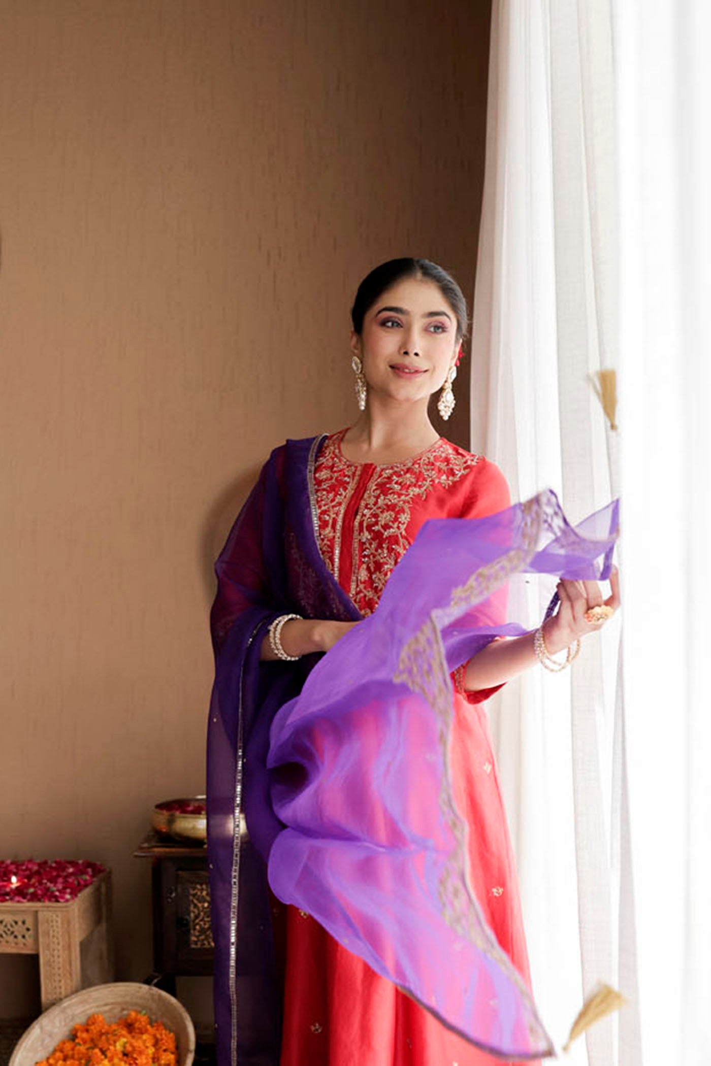 Red kurta set with purple dupatta and fine embellishments