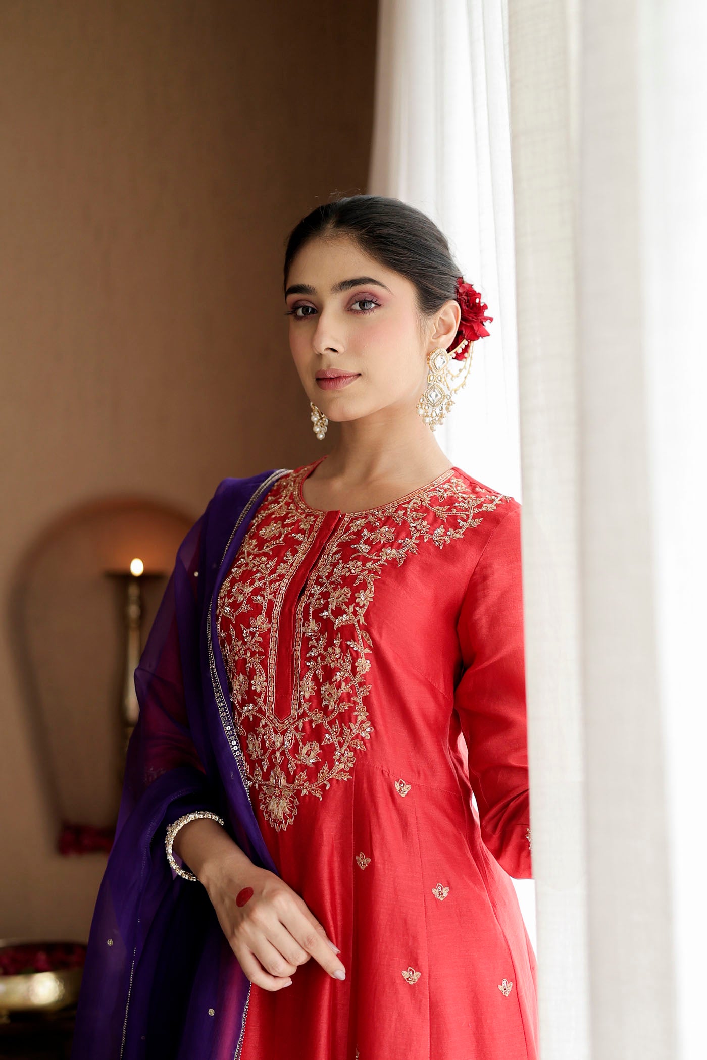 Red kurta set with purple dupatta and fine embellishments