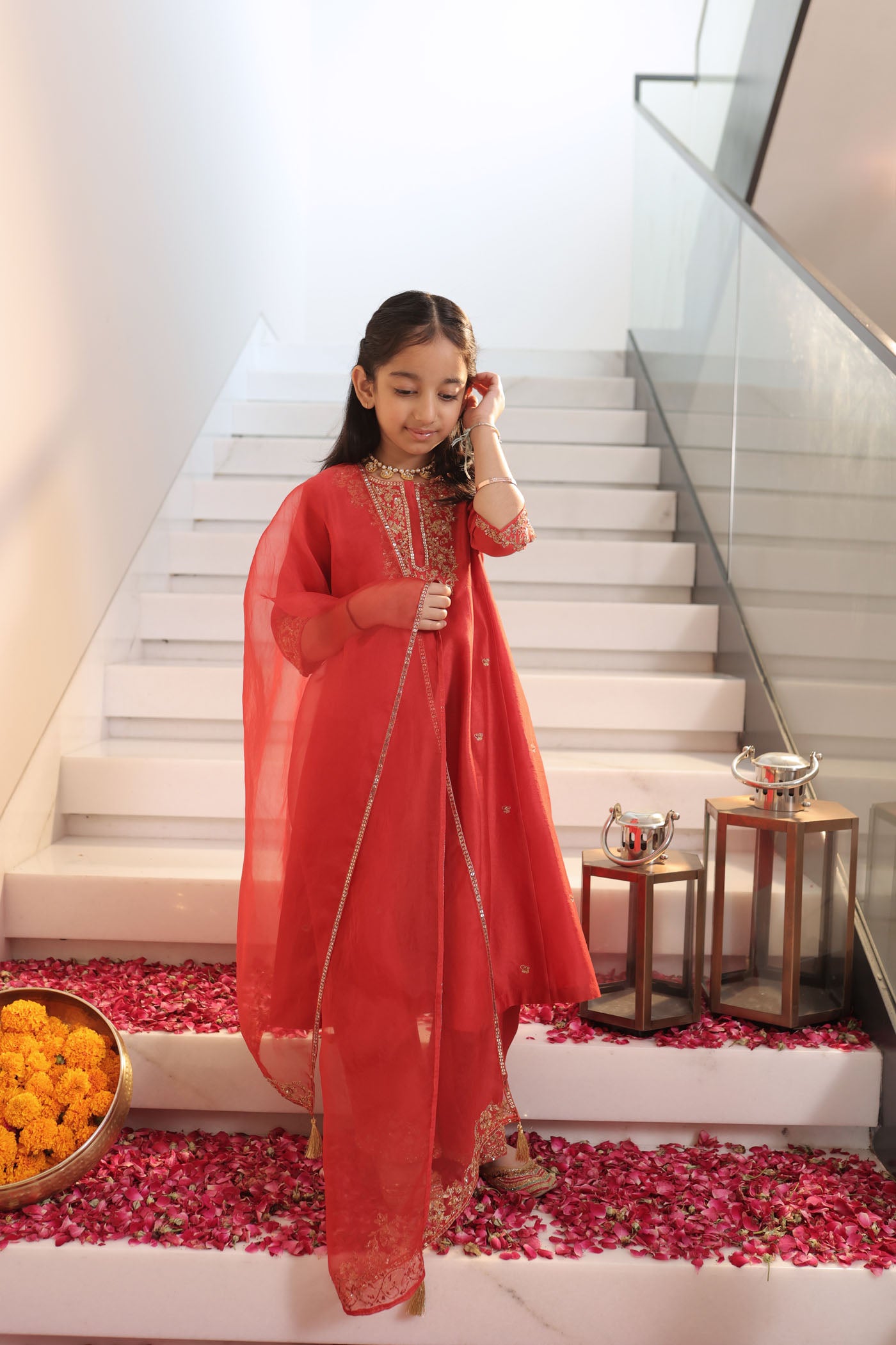 Vibrant red suit adorned with delicate golden zari embroidery and subtle detailing for an elegant festive charm