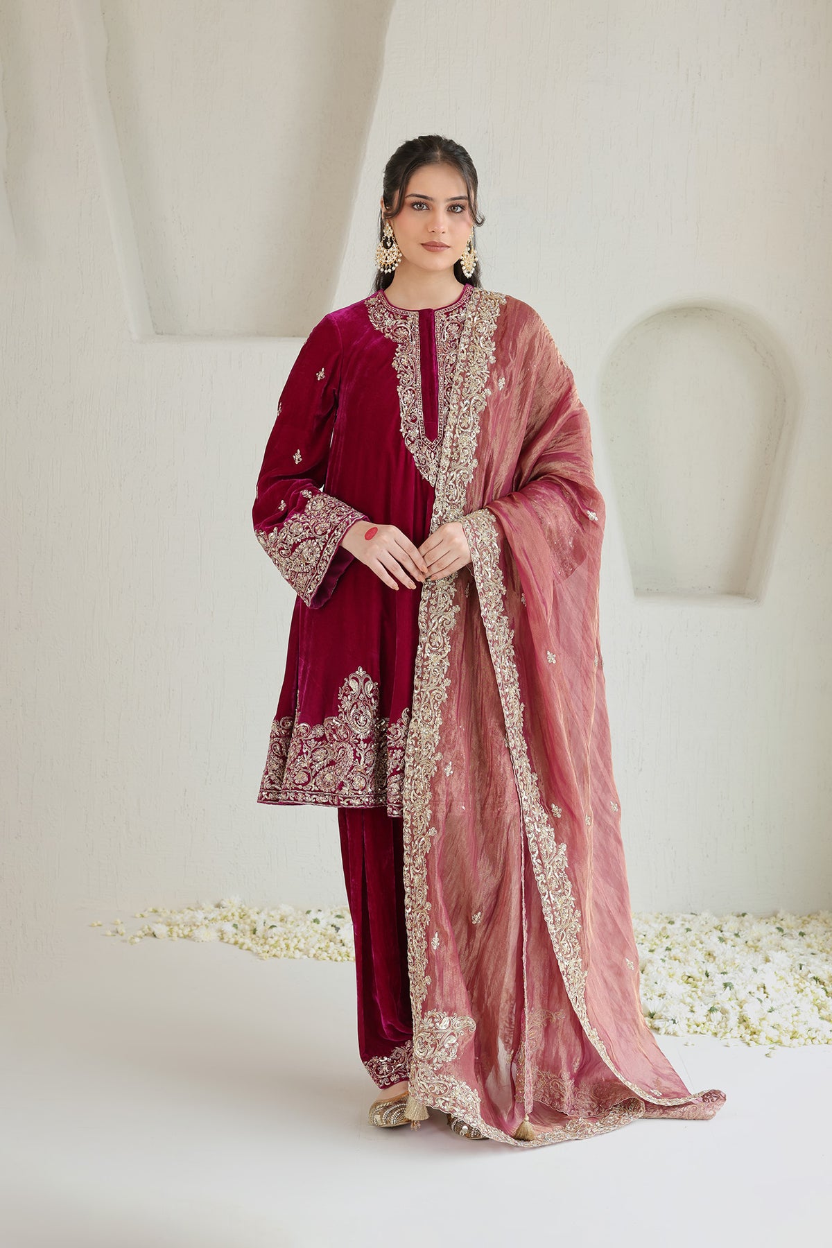 Bright pink velvet paired with a soft blush dupatta and intricate antique-gold embroidery