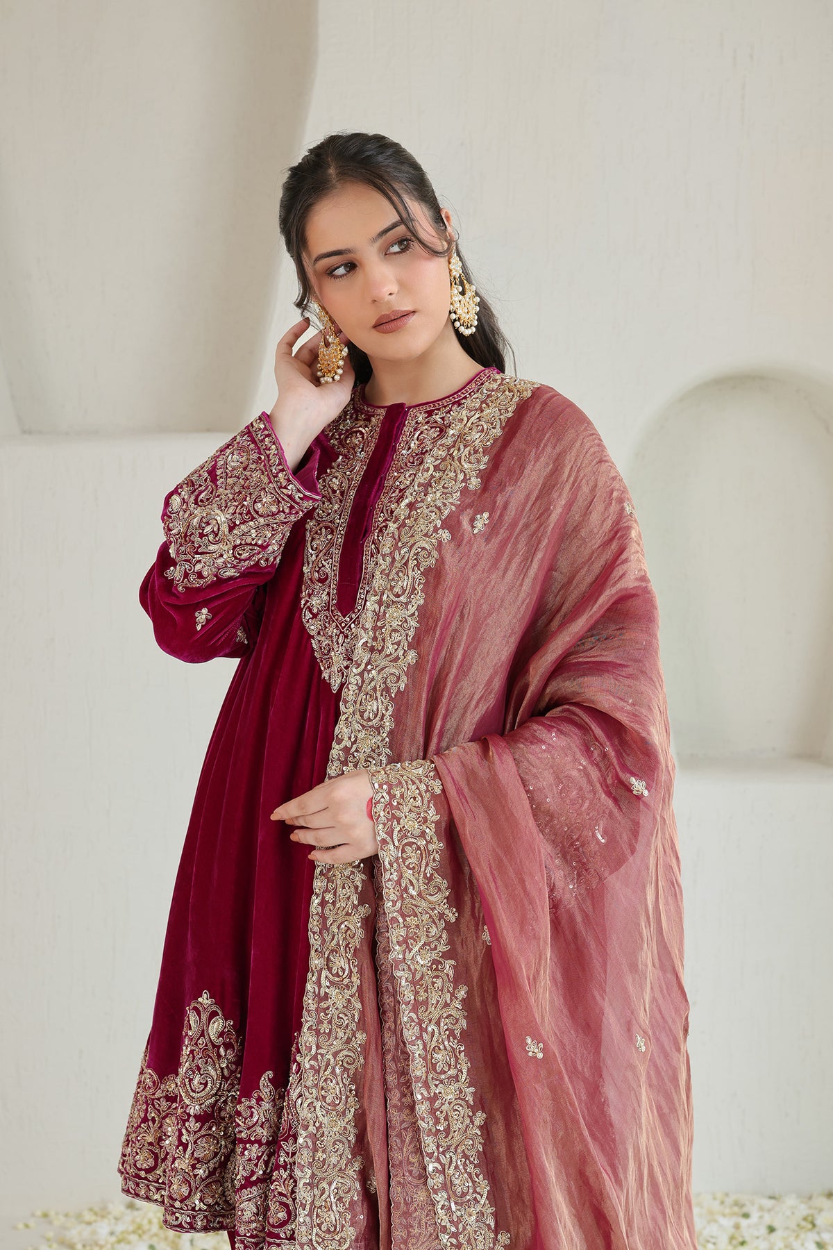 Bright pink velvet paired with a soft blush dupatta and intricate antique-gold embroidery