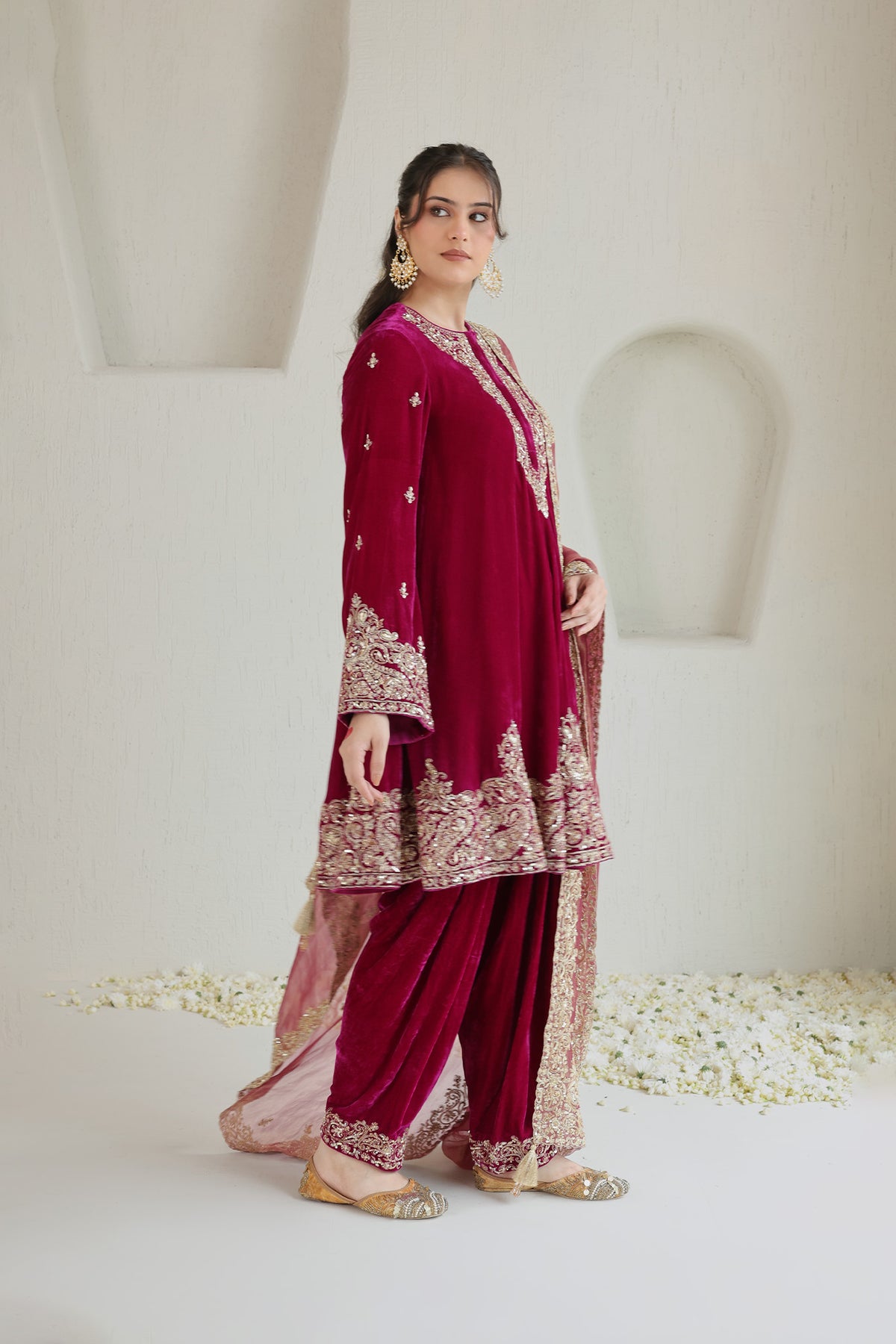 Bright pink velvet paired with a soft blush dupatta and intricate antique-gold embroidery