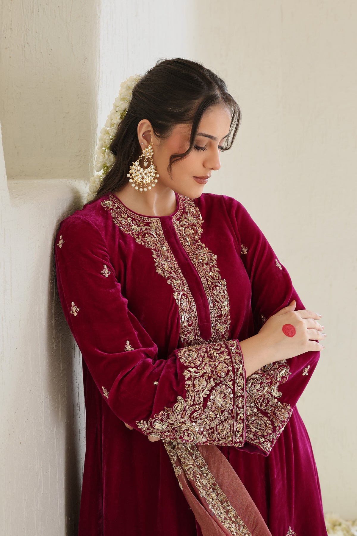 Bright pink velvet paired with a soft blush dupatta and intricate antique-gold embroidery