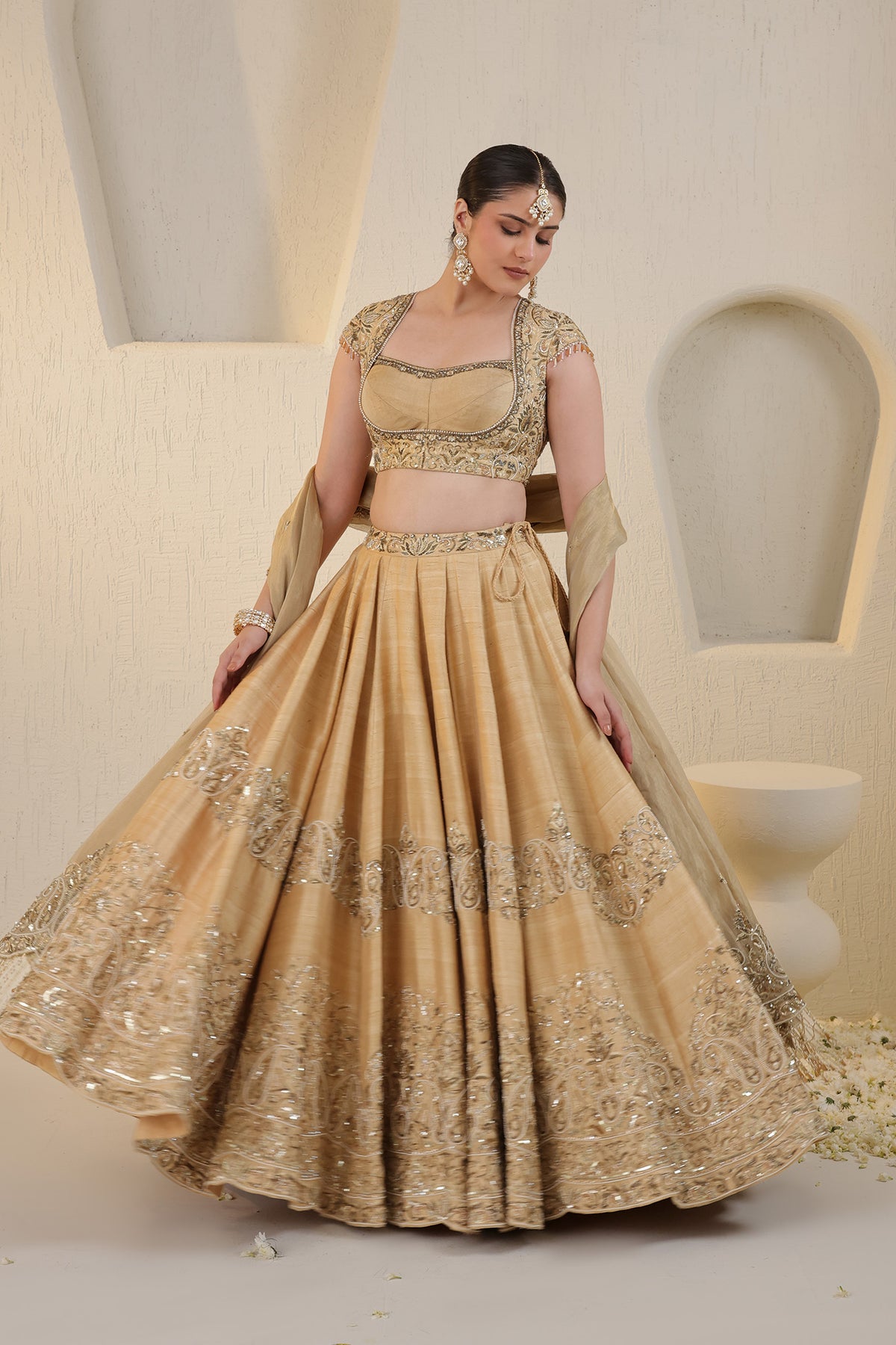 Champagne gold silk lehenga with gold embellishments
